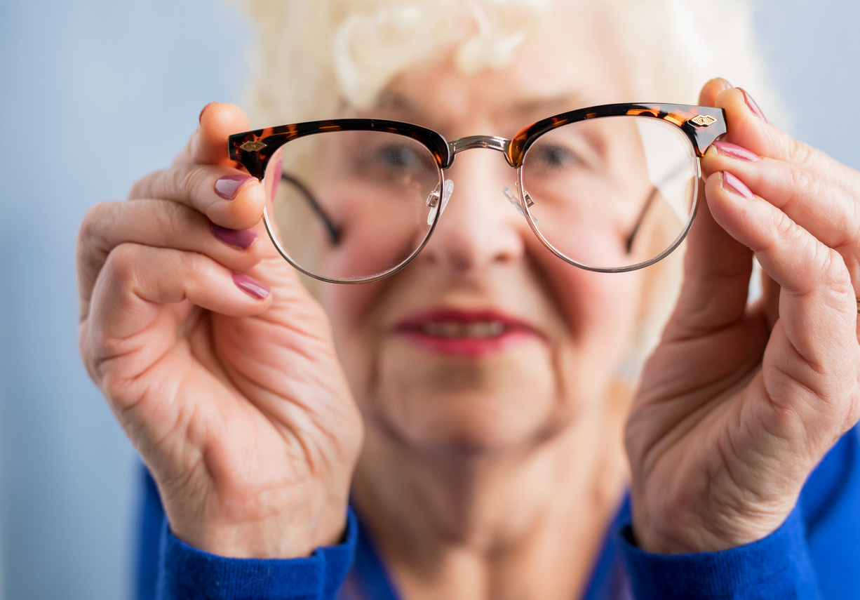 Elderly woman looking through glasses
