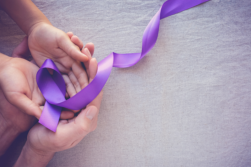 Hands holding Purple ribbons