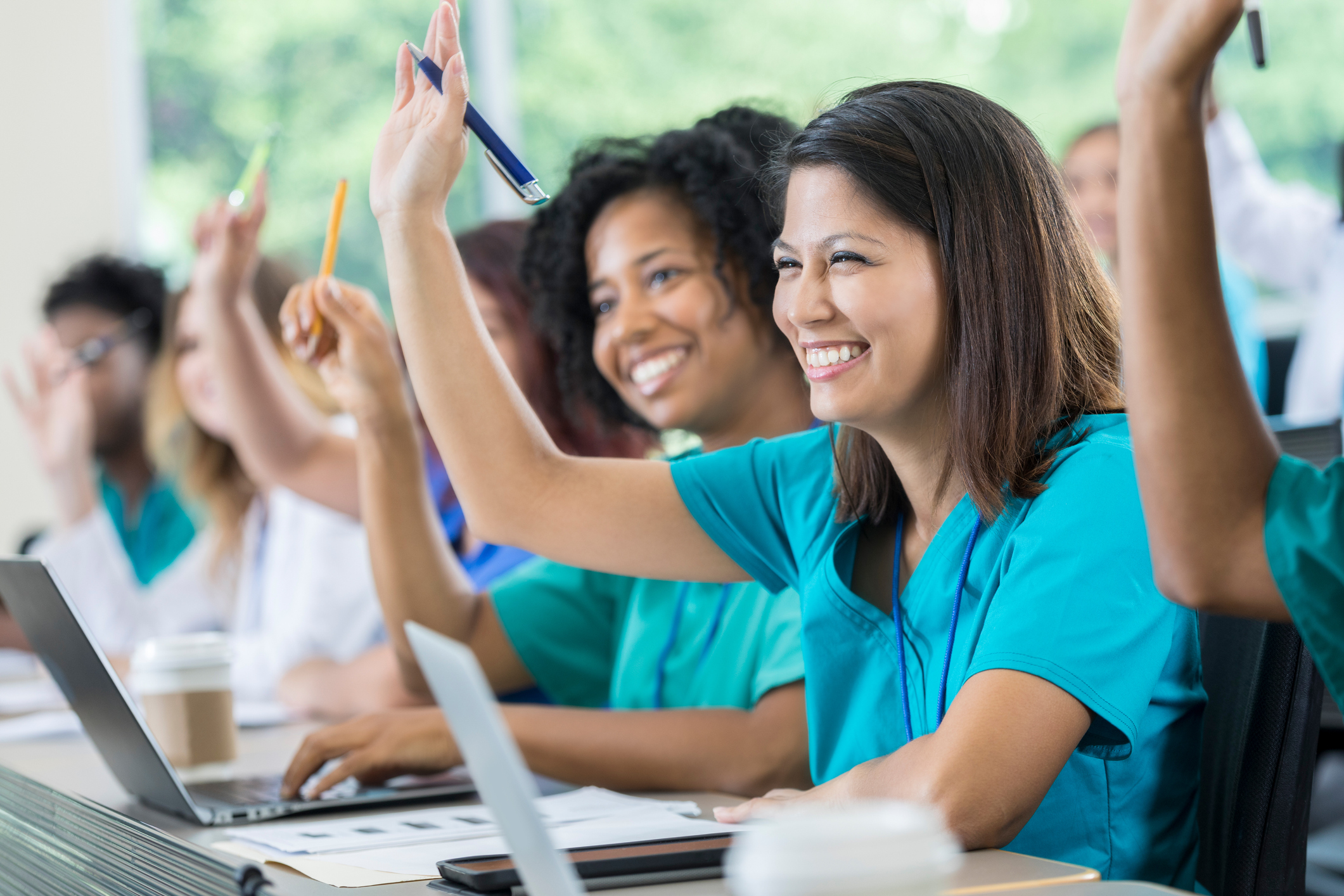 Healthcare workers raise their hands