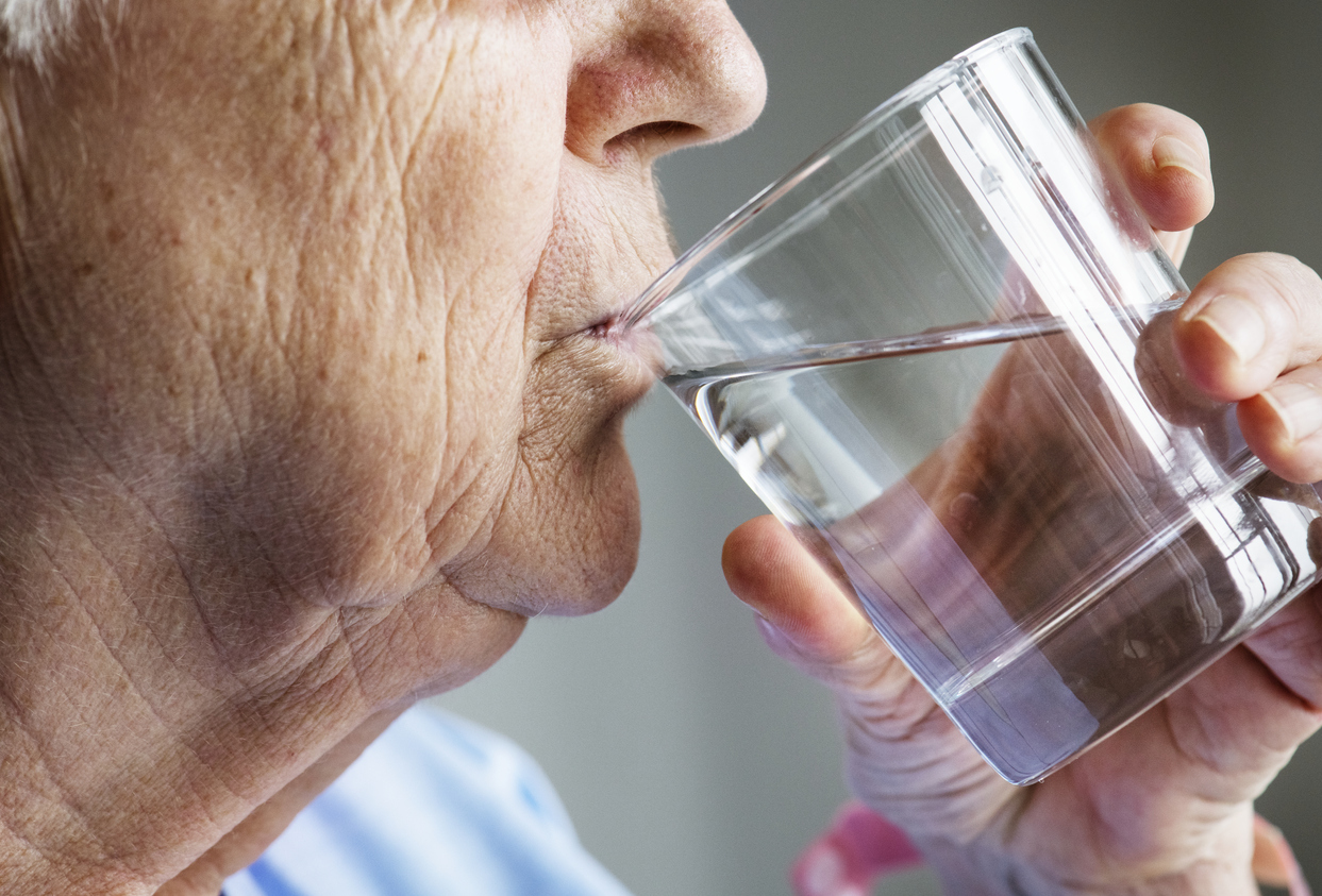 elderly woman drinking water