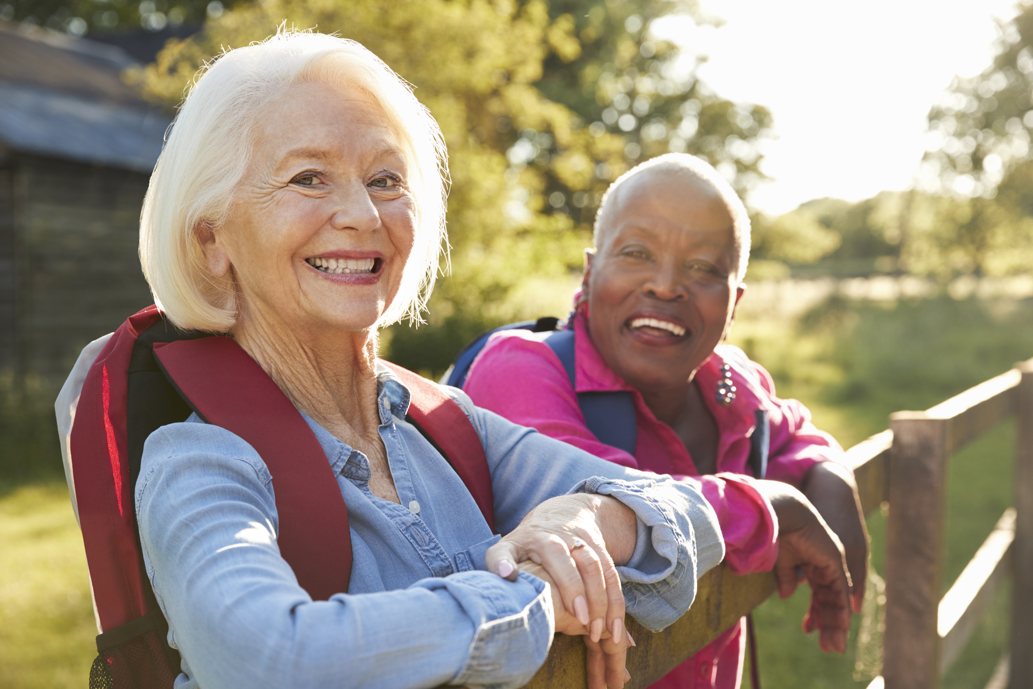 Two Female Senior Friends Hiking In Countryside